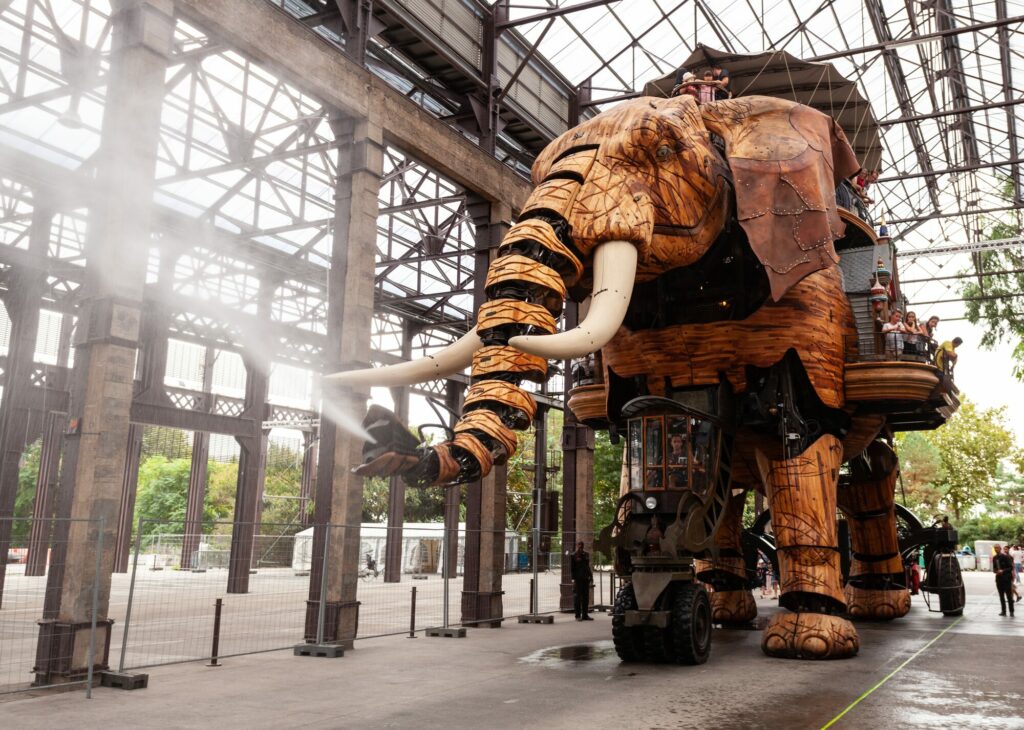 Le Grand Éléphant mécanique des Machines de l'île à Nantes sous la verrière des Nefs, crachant un jet de vapeur