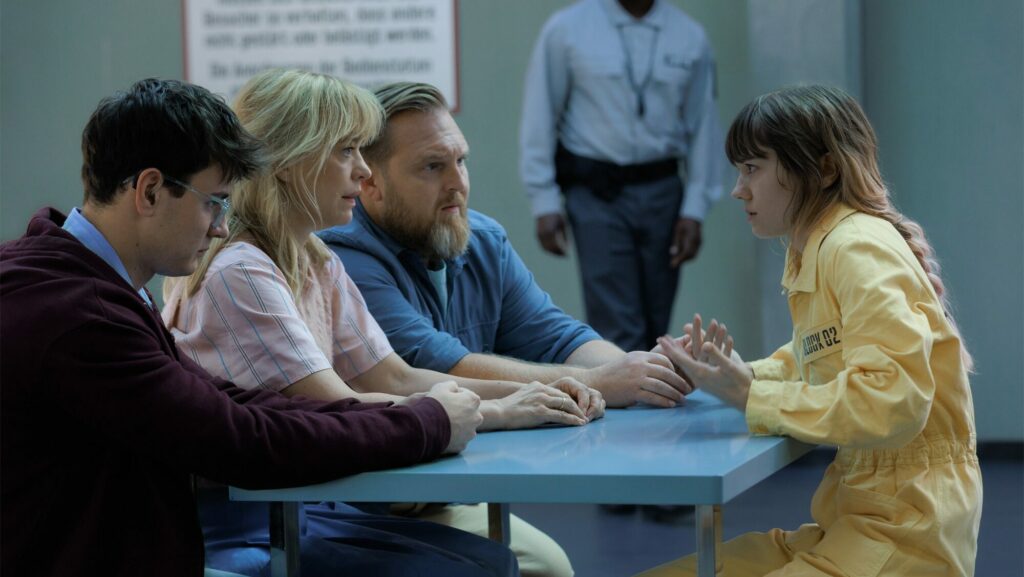 Lea Drinda en veste jaune face à Heike Makatsch, Axel Stein et Leo Simon autour d'une table de parloir dans la série Where's Wanda