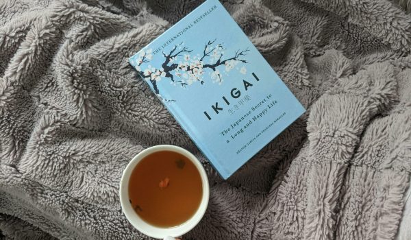 Enjoy a relaxing day with Ikigai and a cup of tea on a soft blanket, perfect for leisure time.